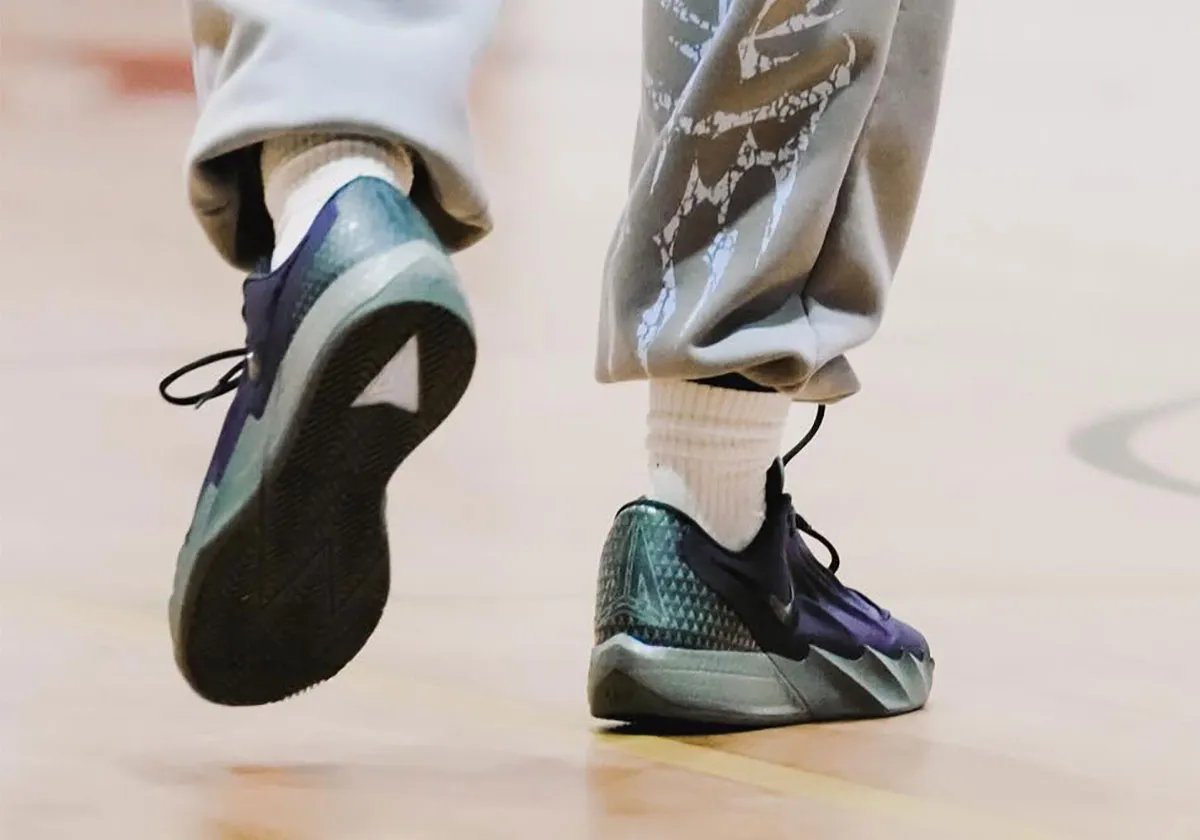 Side profile view of Nike Ja Morant Twelve Time showing wave-sculpted midsole, herringbone traction pattern, and lateral Swoosh branding - detail view 1