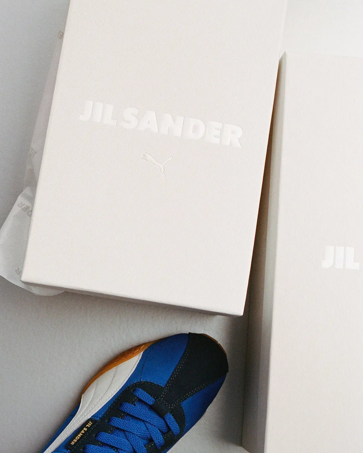 PUMA x Jil Sander K-Street sneaker in blue and navy colorway, showing low-profile sole and layered panel construction - detail view 3