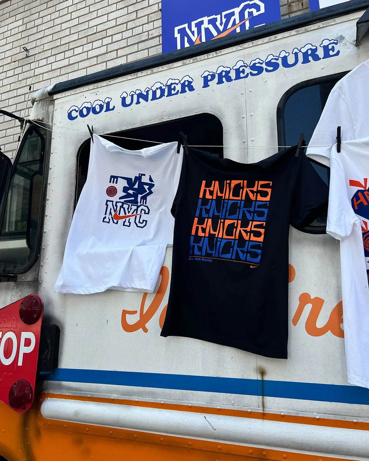 Nike Park N Shop pop-up activation inside Park N Lock garage near Madison Square Garden, featuring custom orange and blue ice cream truck design with vintage Knicks merchandise and hanging Nike Dunks - detail view 2