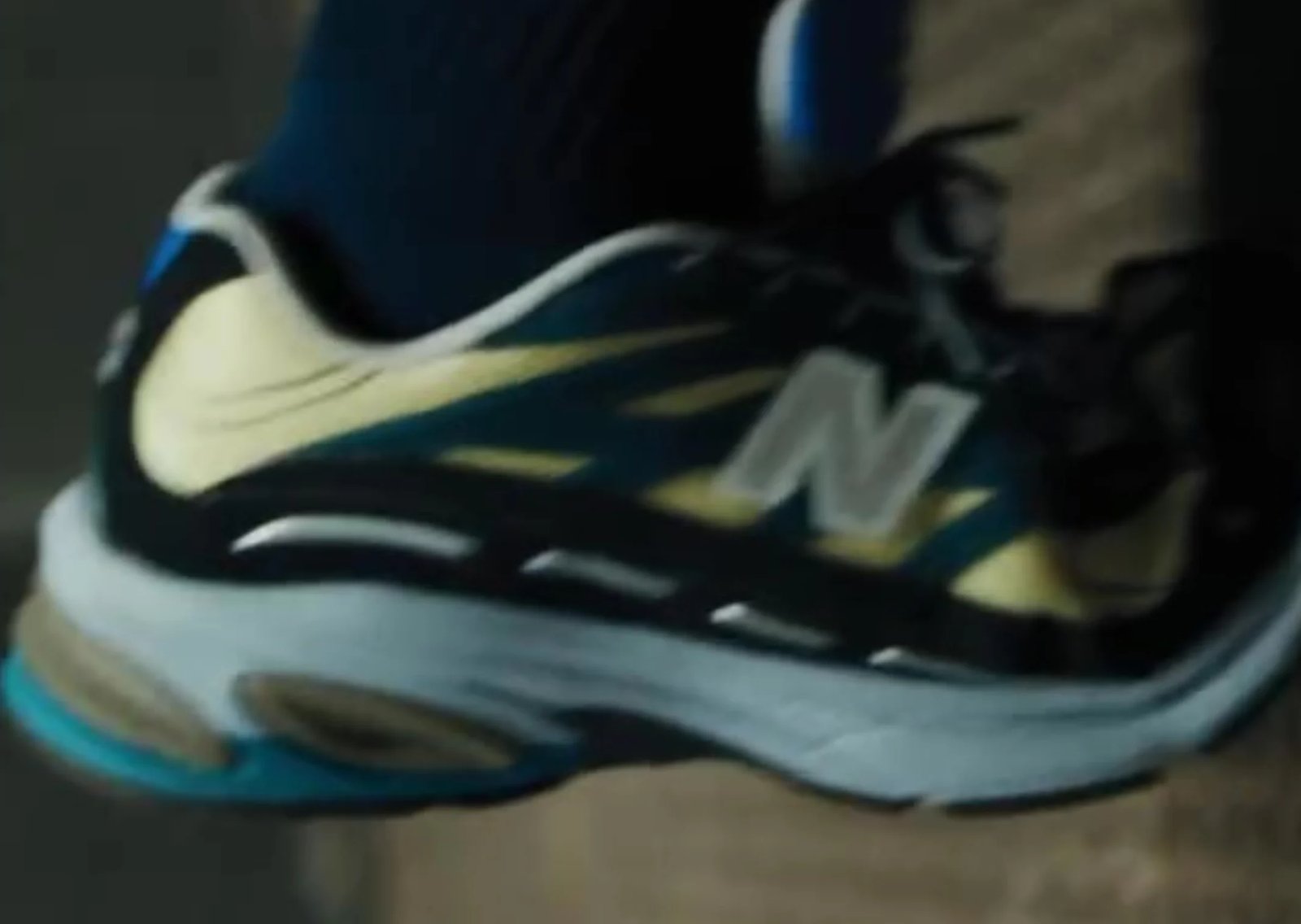 Action Bronson wearing the New Balance 2811 Baklava colorway during film trailer preview, featuring pale yellow mesh, dark blue uppers, and multi-tonal midsole - detail view 2