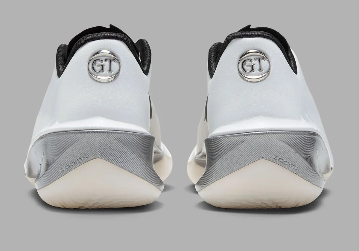 Nike GT Cut 4 SE in Summit White colorway featuring white synthetic upper, black interior, brushed metallic silver heel, and semi-translucent outsole - detail view 5