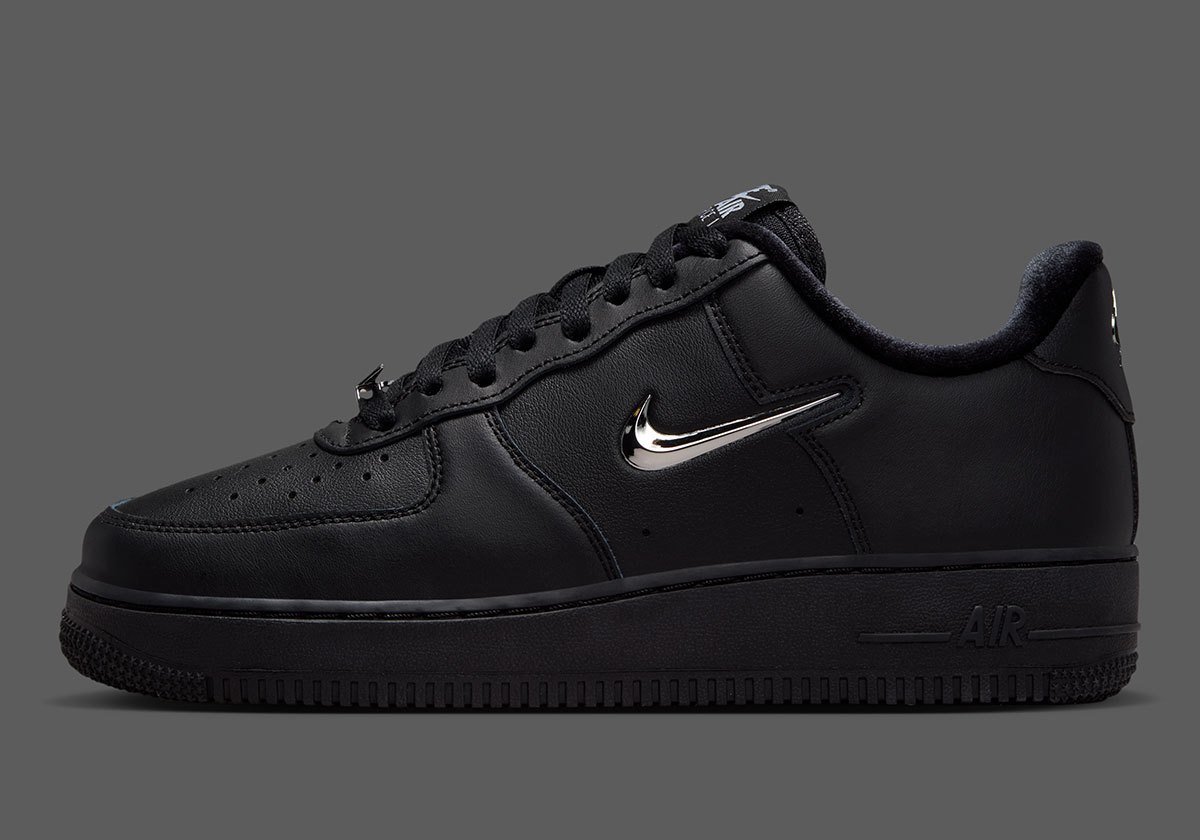 Nike Air Force 1 Low in black leather with chrome silver Swoosh detail, side view - detail view 1
