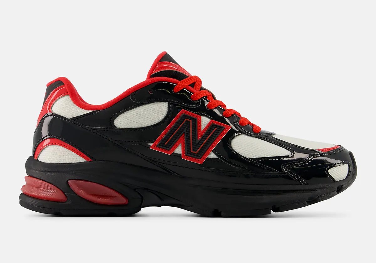 New Balance 2010 Firecracker colorway featuring off-white mesh, jet black patent leather, and fire red accents - detail view 1