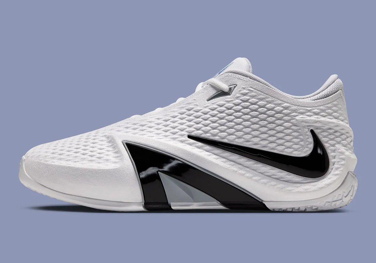 Nike Ja 4 in White with Cobalt Bliss, Photon Dust, and Black colorway, showing the white upper, black Swoosh, and A-Frame detail - detail view 1