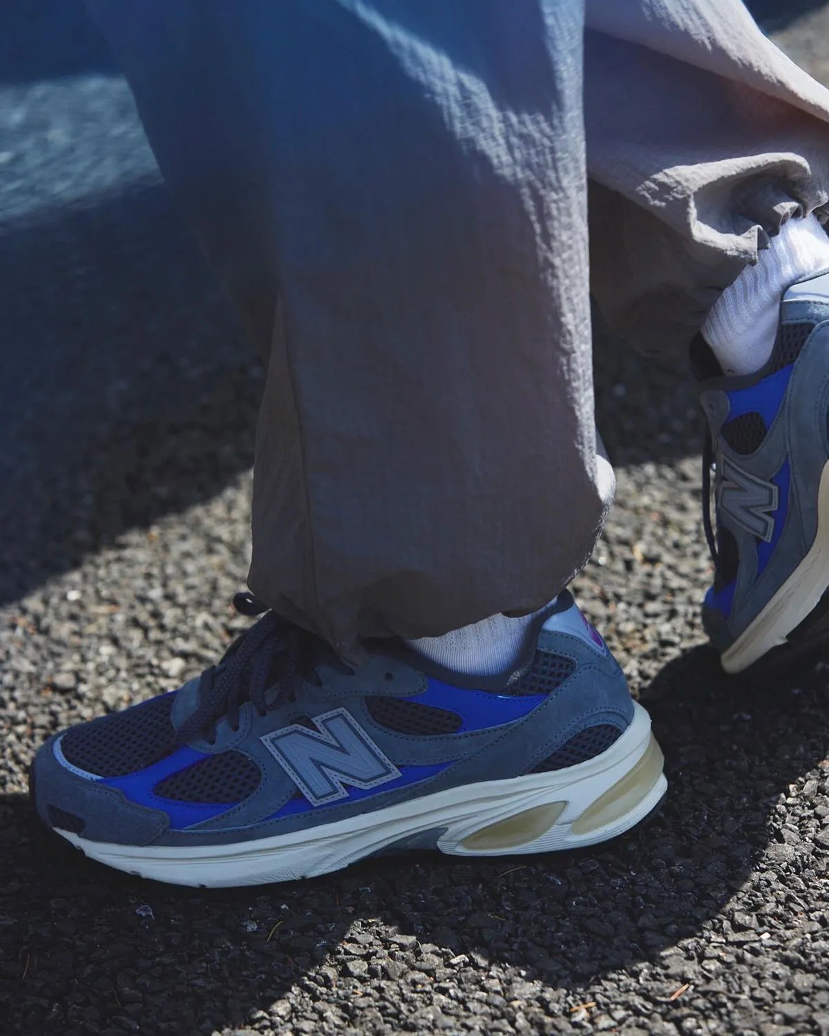 Liberaiders x UNIK x New Balance 2010 'Walk Together, Bonded by True Friendship' sneaker with grey mesh upper, blue underlays, and purple branding accents - detail view 1