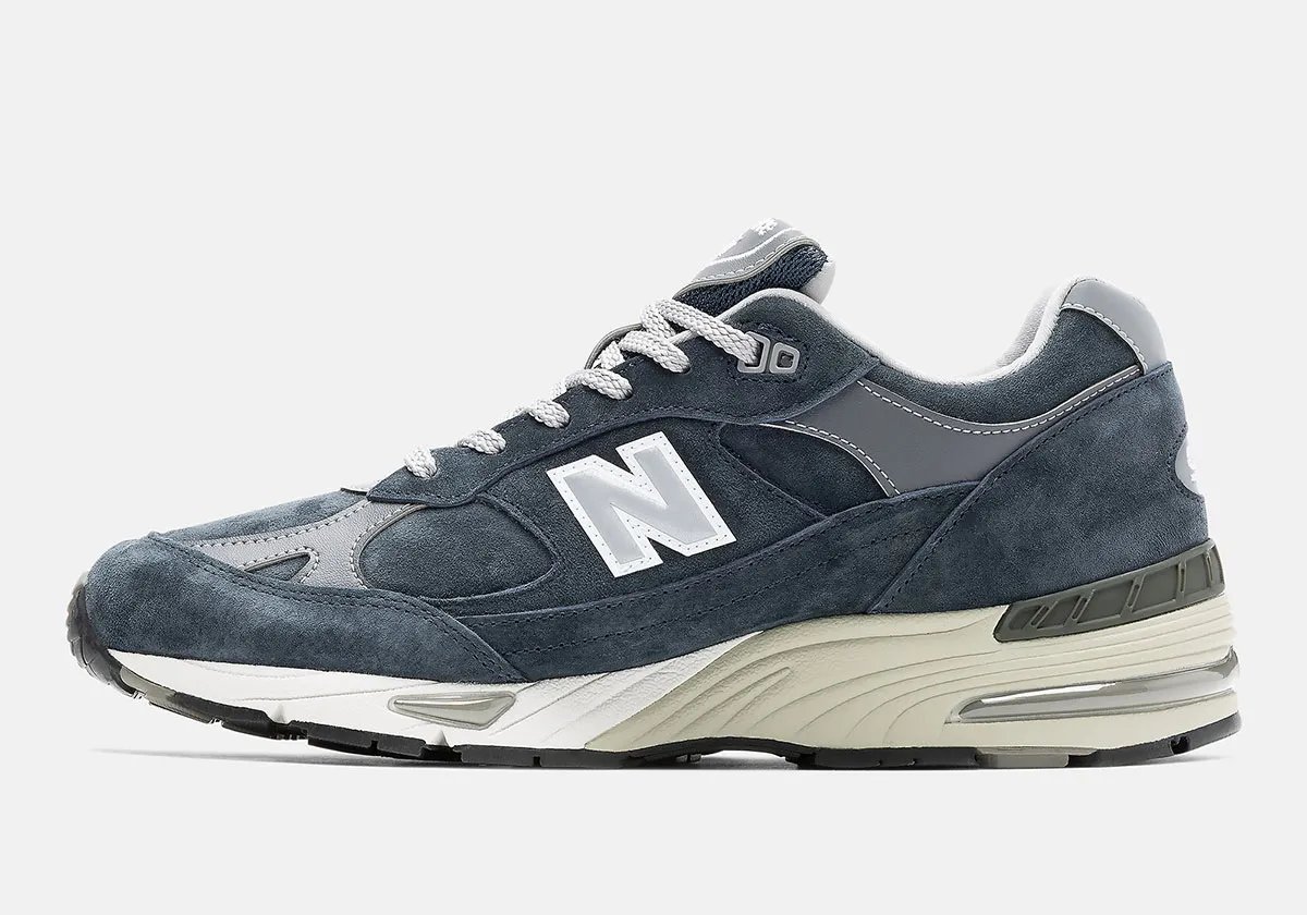 New Balance 991 Essential in black and navy colorways featuring premium nubuck uppers and white contrast sole units - detail view 2