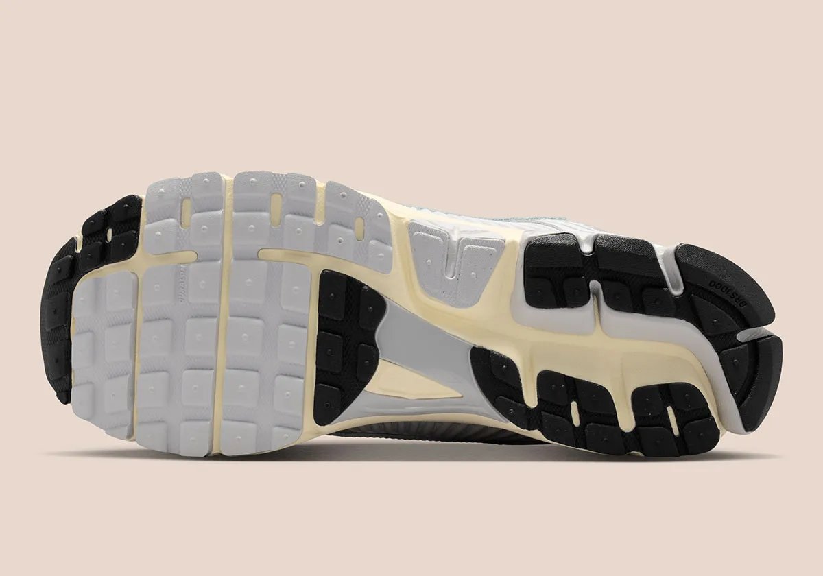 Nike Zoom Vomero 5 in Grey Fog colorway, showcasing the layered mesh upper and visible Zoom Air cushioning - detail view 2