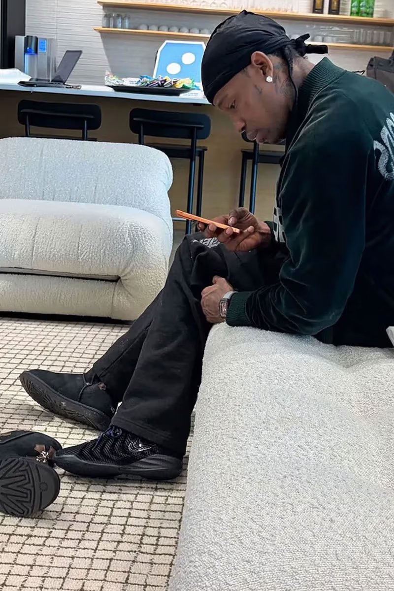 Travis Scott wearing unreleased Nike Caitlin 1 all-black sample with raised CC mesh siding and stacked inset Swoosh design - detail view 3