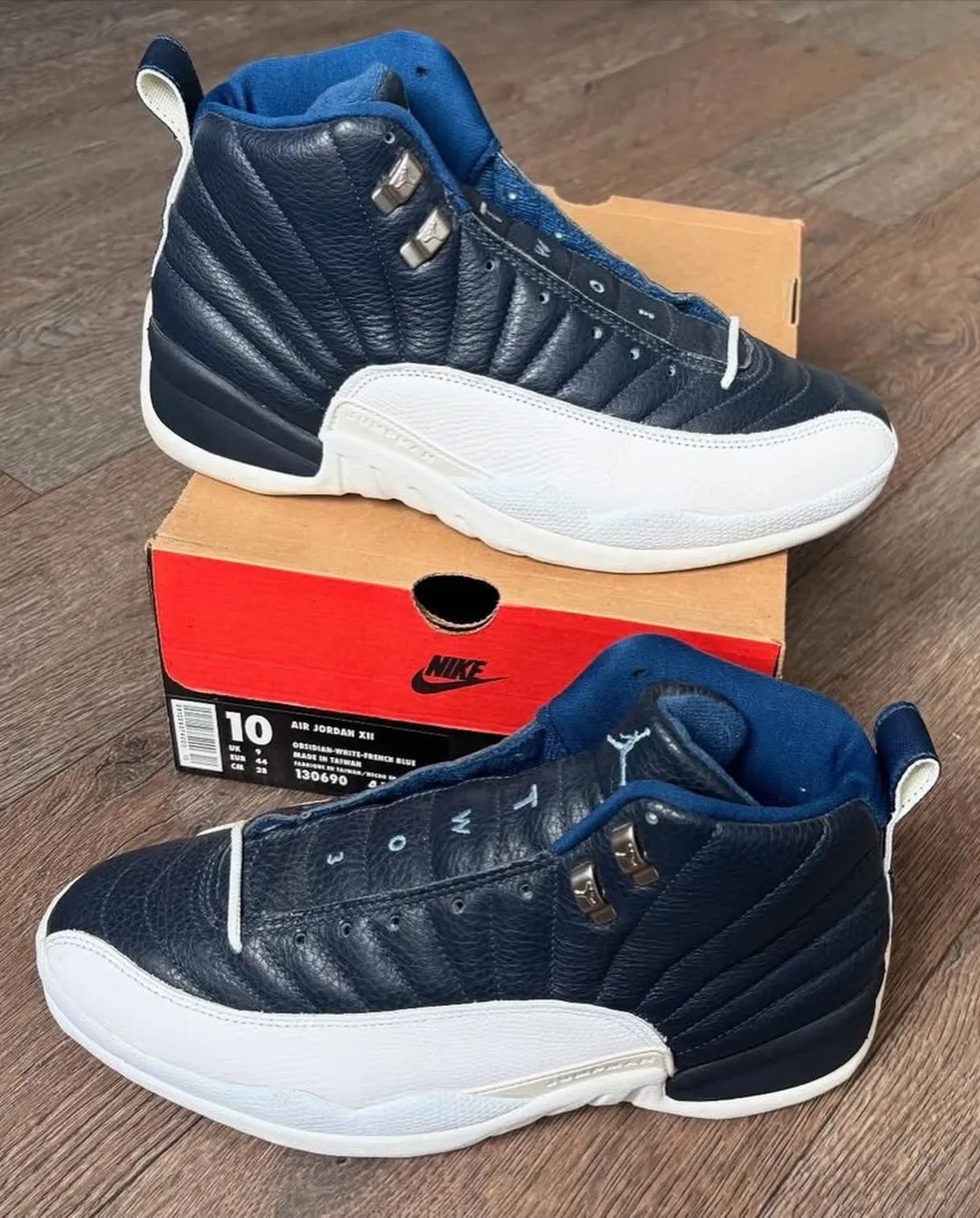Air Jordan 12 Obsidian in navy leather with white mudguard and Carolina blue accents, releasing January 2027 - detail view 2