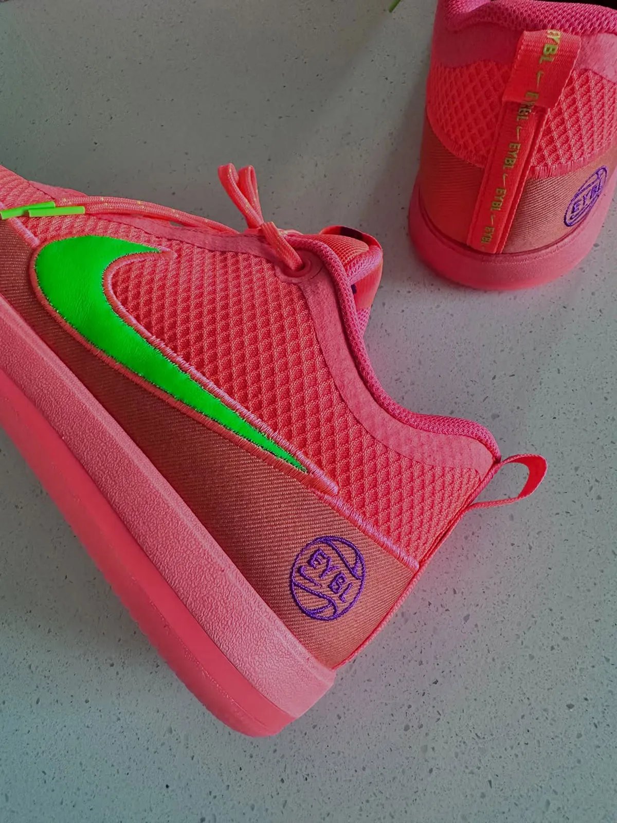 Nike Book 2 EYBL PE in pink and green colorway with chain-link mesh upper and purple accents - detail view 1