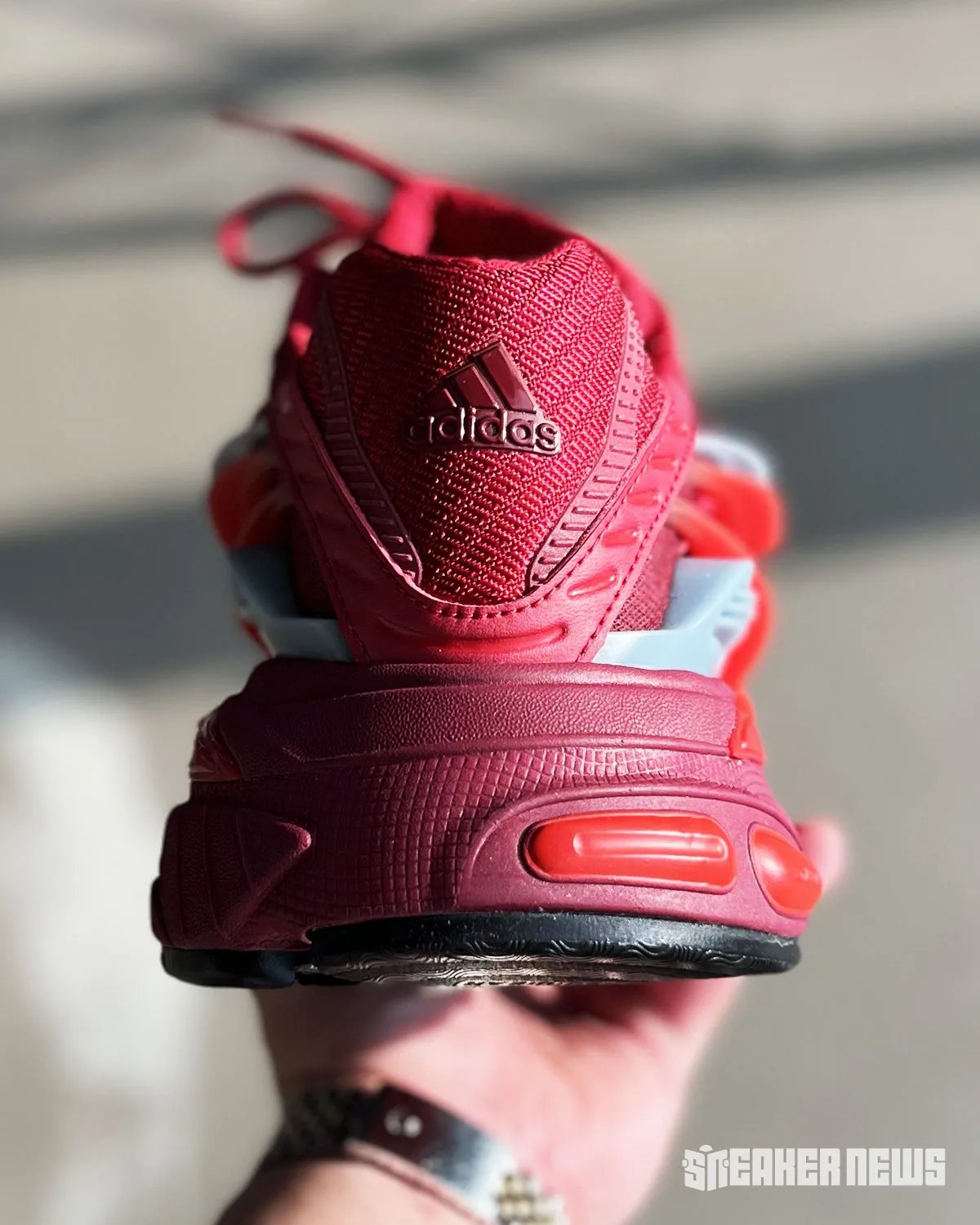 Pharrell's adidas VIRGINIA Jellyfish in red colorway with grey tentacle accents and black Three Stripes - detail view 1
