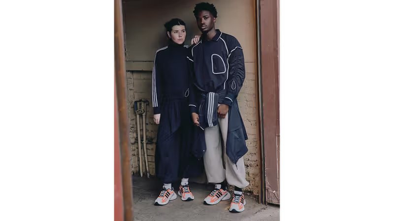 Adidas ADISTAR XLG in Black/Silver and White/Solar Orange colorways with mixed material construction and Y2K-inspired design details - detail view 3