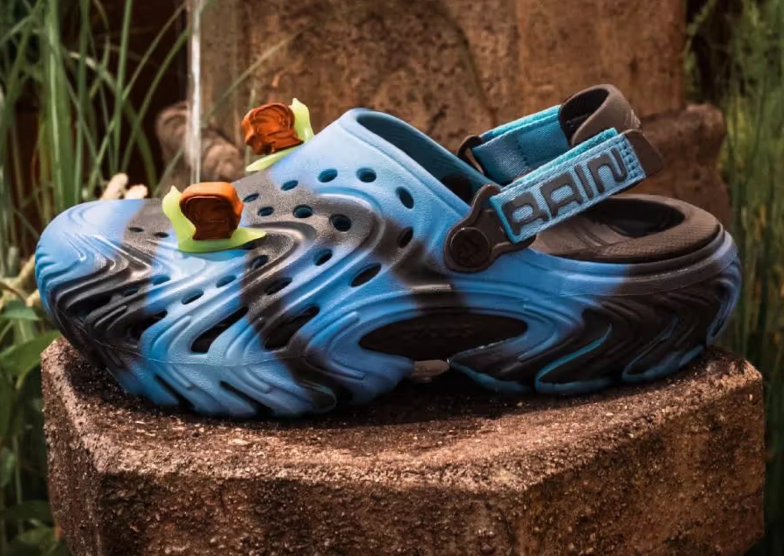 Brain Dead x Crocs Echo II in tide-pool blue and black with co-branded heel strap and neon green Jibbitz - detail view 1