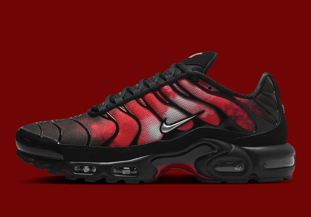 Nike Air Max Plus Flairemax in black with red flame graphic, metallic silver Swoosh, and metal lace tips - detail view 2