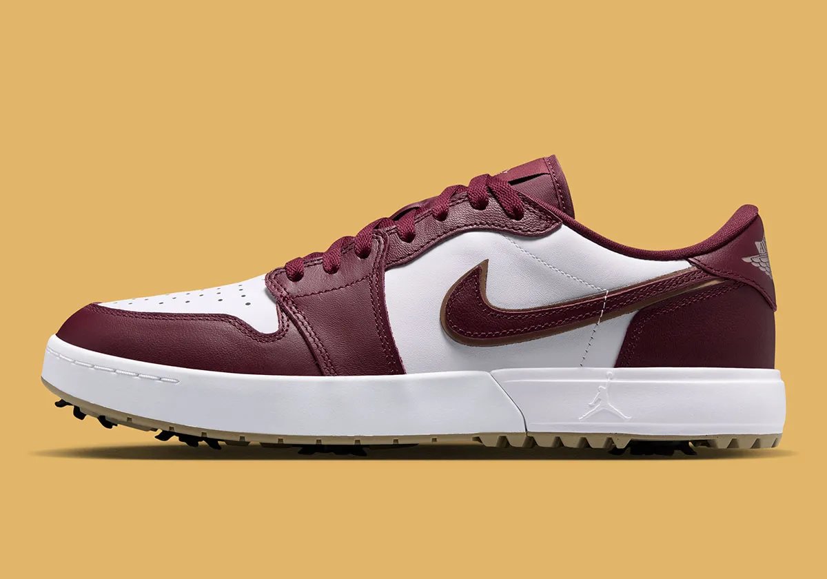 Air Jordan 1 Low Golf Spike in Dark Team Red showing burgundy overlays, khaki outsole, and strategic spike placement - detail view 1