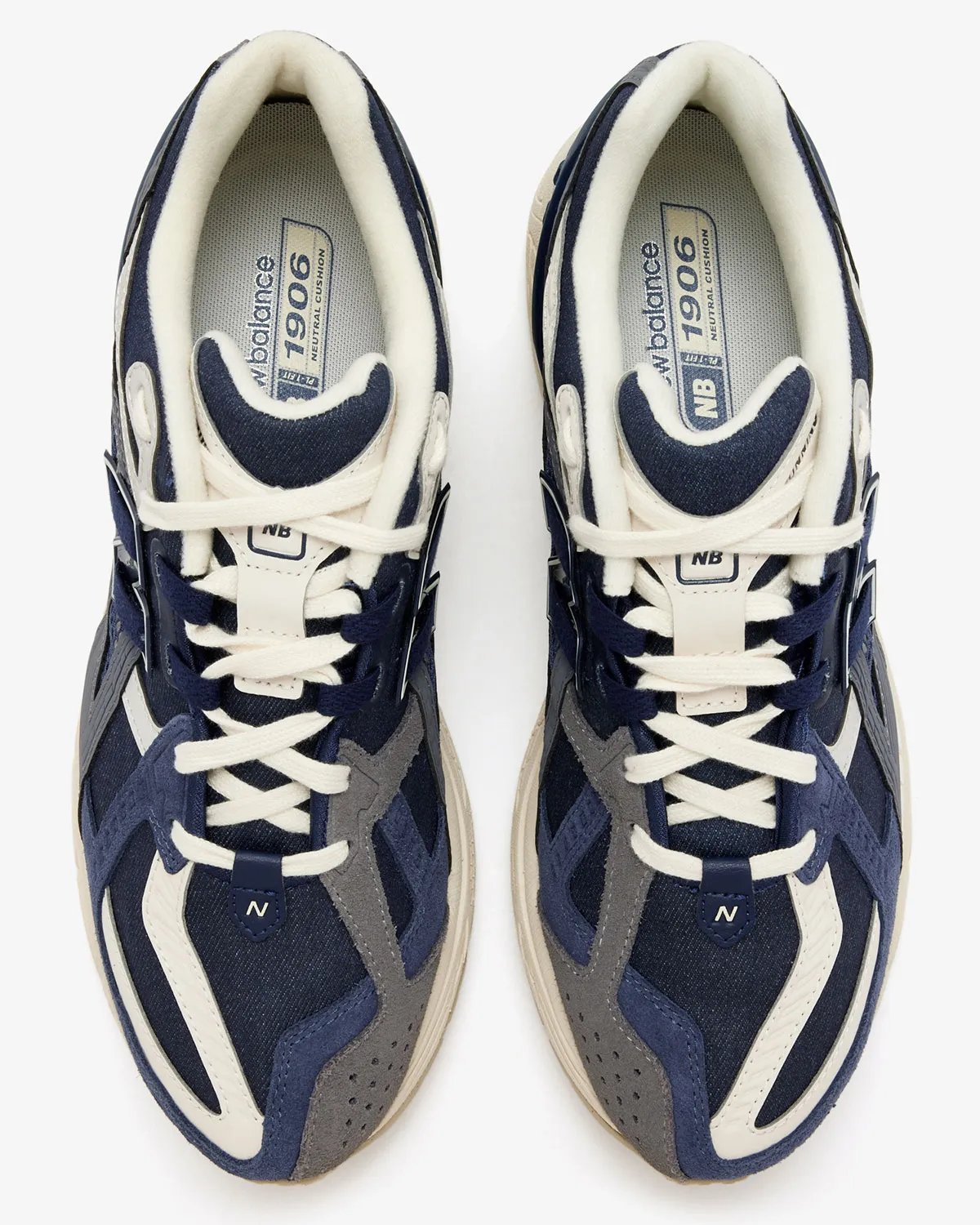 New Balance 1906U in navy and off-white colorway, showing side profile of the lifestyle sneaker - detail view 2