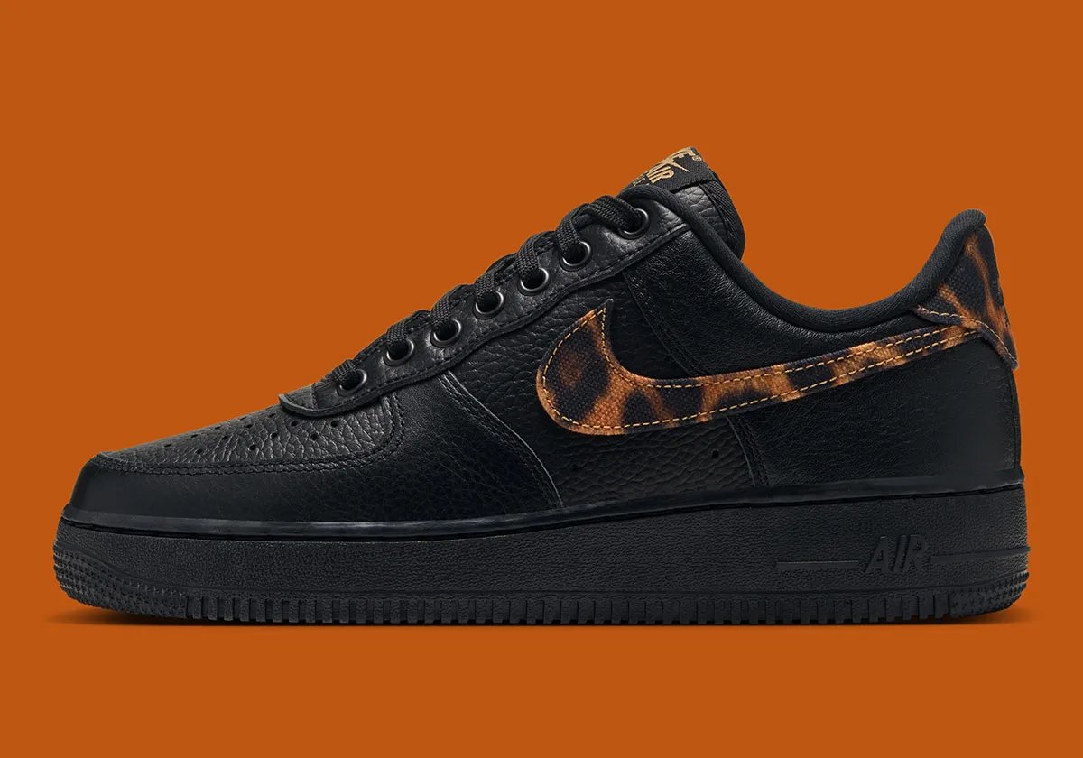 Nike Air Force 1 Low in black tumbled leather with leopard print detailing on the Swoosh and heel tab - detail view 1