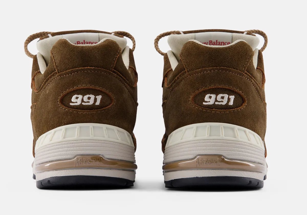 New Balance 991v1 in Coffee Suede colorway featuring premium pig suede upper with earthy brown tones and white/black sole unit - detail view 3