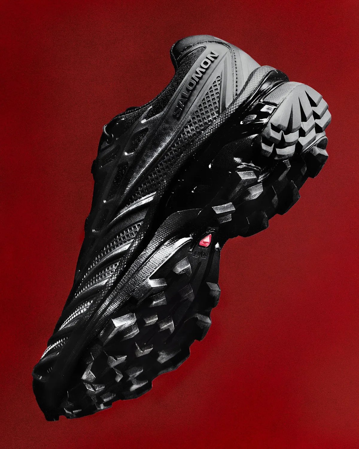 Salomon XT-EVO featuring liquid rubber cage construction in Black/Fiery Red colorway - detail view 1